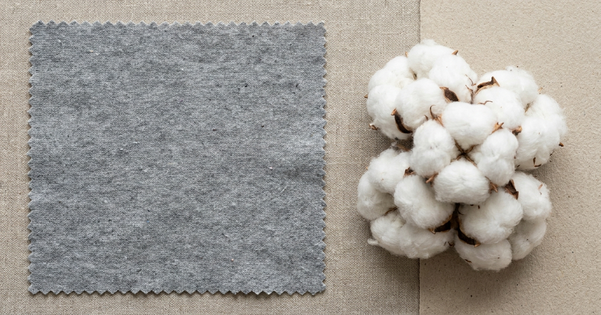 Recycled polyester fabric swatch next to raw organic cotton bolls, neutral flat-lay background Recycled polyester fabric swatch next to raw organic cotton bolls, neutral flat-lay background