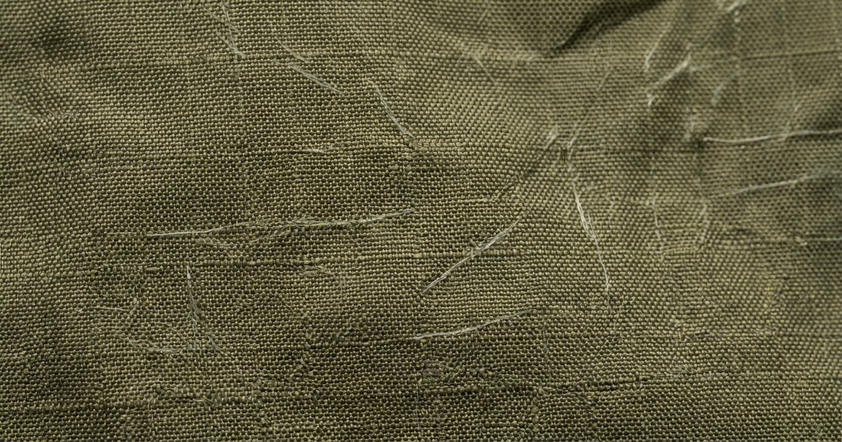 Close-up of grid-weave ripstop nylon fabric with a faint ghost-net texture woven through it Close-up of grid-weave ripstop nylon fabric with a faint ghost-net texture woven through it